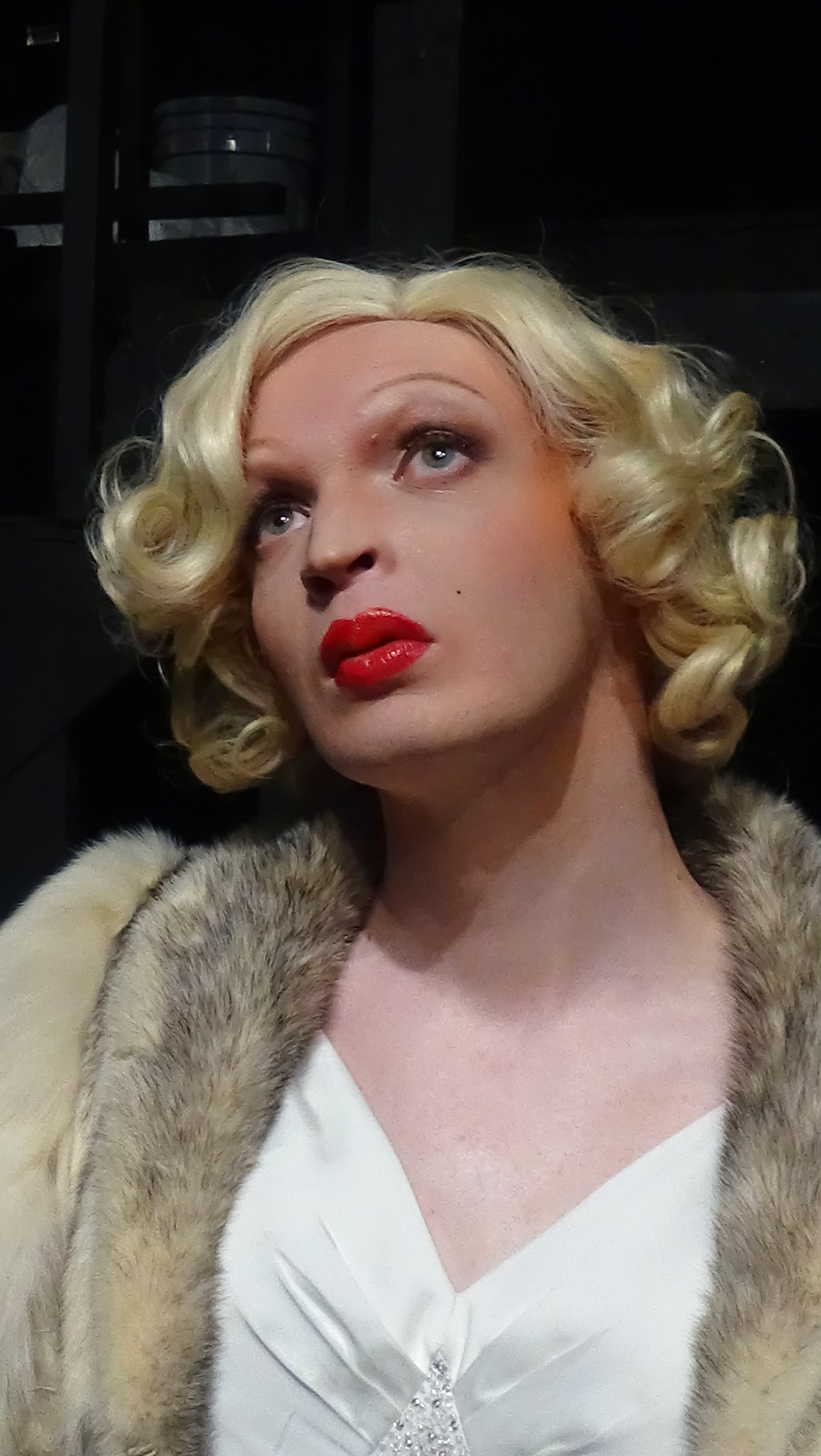 Close up of Brooks Ginnan dressed as marilyn monore with glamorous makeup and bright red lipstick